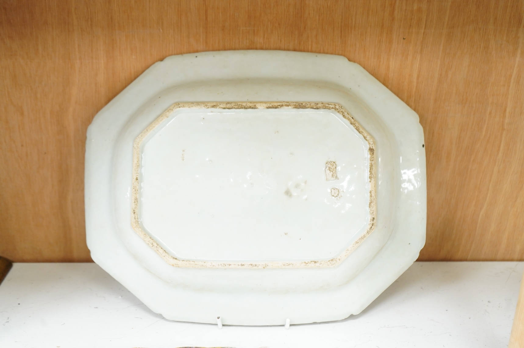 A late 18th century Chinese export blue and white serving dish and a similar famille rose serving platter, largest 37.5cm